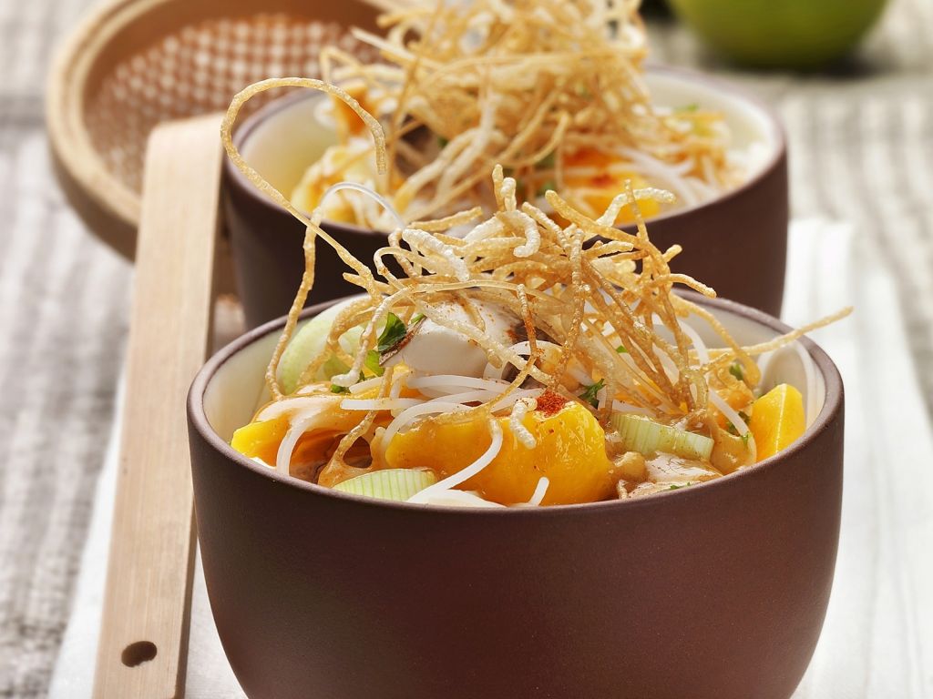 Nudelsuppe auf chinesische Art mit Zwiebel, Mango und knusprigen Nudeln ...
